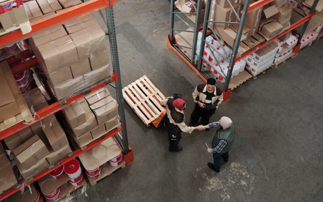 people having a discussion inside a warehouse