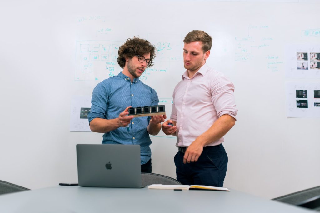 photo of two guys discussing the features of a product